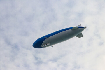 Fototapeta na wymiar Blimp, airship or dirigible flying in sky