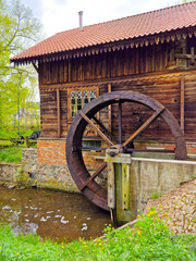 old house on the water with a watermill at the museum of agriculture in Ciechanowiec, Poland