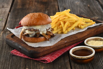 Tasty smoked ribs burger with crispy hamburger buns,cheese,ketchup,mayonnaise and french fries