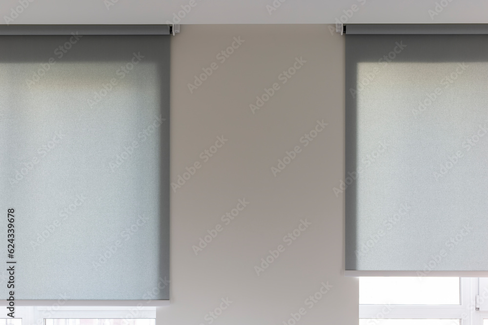 Poster roller blinds automatic close-up on the window. selective focus. motorized shades. gray color curtai