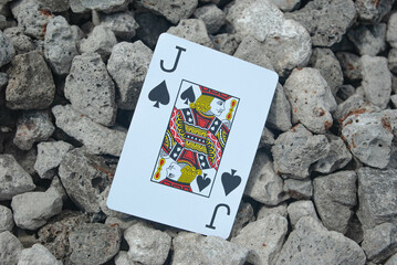 Poker cards joker, on the background of stones
