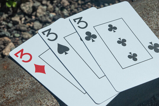 Poker cards, set combination, on railway sleeper