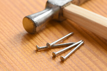 Hammer and nails on a carpenter's workbench.