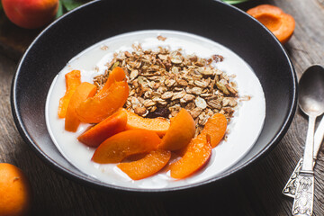 Granola with yogurt and apricots in a bowl
