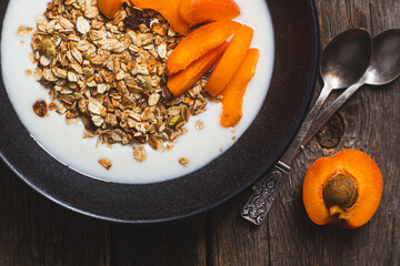 Granola with yogurt and apricots in a bowl