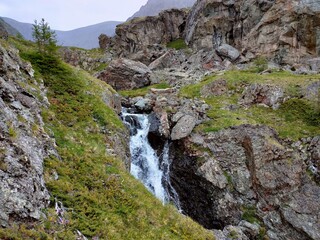 Fototapeta na wymiar Kosh-Agachsky district, Altai Republic, Russia - 06.30.2022. Mountain waterfall near Kuekhtanar lakes