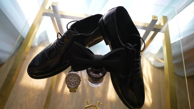 Groom's Accessories with the bow tie on the table for the Wedding Day