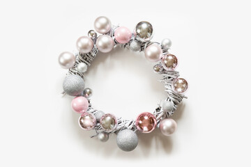 Christmas white wreath of silver and pink balls, painted vine on white background.