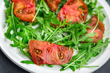 red tomato salad arugula healthy meal food snack on the table copy space food background rustic top view 