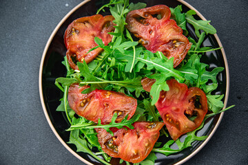 red tomato salad arugula healthy meal food snack on the table copy space food background rustic top view 
