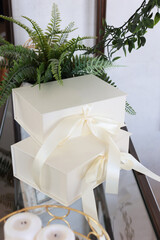 Boxes with gifts on the table. Boxes tied with bows. The concept of holidays.Vertical photo.