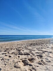 Fototapeta na wymiar sand beach, blue sky and sea