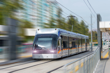 Fototapeta premium Modern comfortable tram moves along the streets of the city, electric transport.