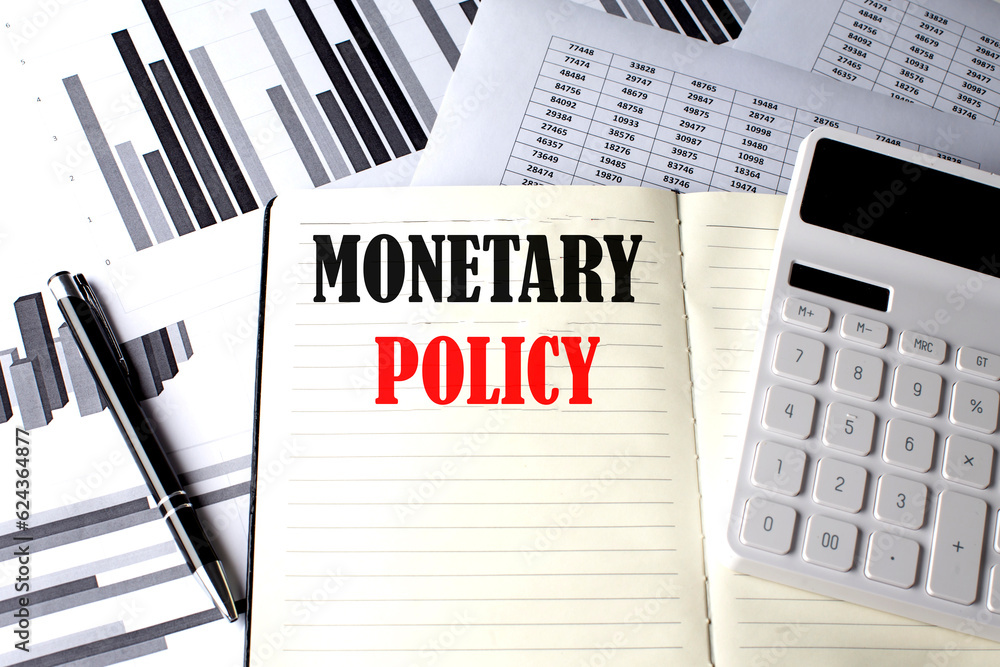 Poster monetary policy text written on a notebook on chart and diagram