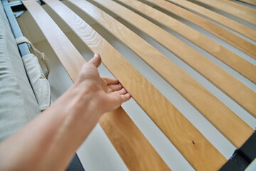 Close-up of wooden slats on the bed
