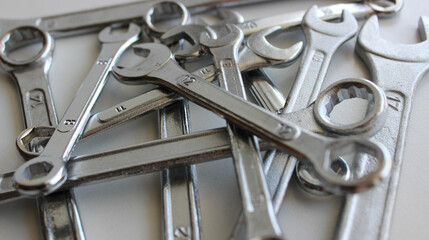 Variety ring wrenches, box end spanners and hex wrenches and on white surface
