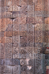 Wall Detail from Qutub Minar monument in Delhi, India or Ancient carved red sandstone background at the Qutb Minar medieval monuments. Beautiful view of the Qutub Minar.