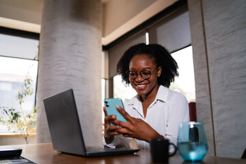 Black businesswoman working on laptop. Portrait of beautiful businesswoman in the office. Woman...