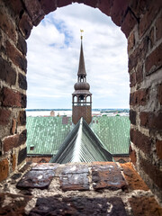 An old building with sharp roofs, peaked roof.