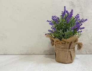 Bouquet of lavender in a vase on a  light table. Copy space.