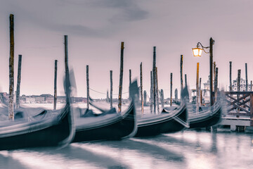 Picture with gondolas moored on Grand Canal near Saint Mark square, in Venice Italy.