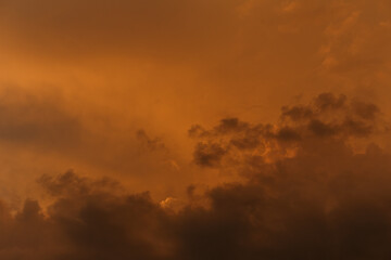 Dramatic fiery blood orange sky. Fantastic golden sunset after the storm. Background for design. Halloween, evil, Armageddon, apocalypse concept. web banner