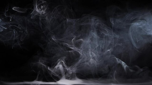 Abstract fog. White cloudiness, mist or smog moves on black background. Beautiful swirling gray smoke. Mockup for your logo. Wide angle horizontal wallpaper or web banner.