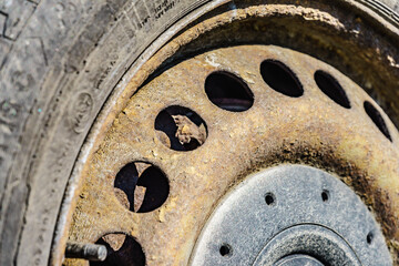 Old rusty car wheel rim closeup