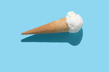 vanilla ice cream and hard shadow on blue background, creative decoration of minimal summer concept