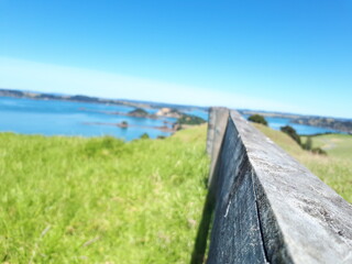 A wooden fence in the beautiful meadows of Bay of Islands, New Zealand