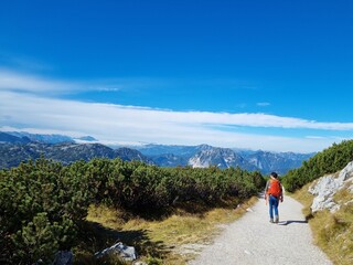 A backpacker travel on the mountains peak in the alpine view of Hallstatt, Austria, Europe