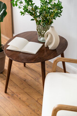 Stylish retro composition of brown side table and white armchair