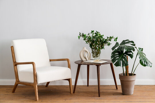 Scandinavian living room composition with designer armchair and side table