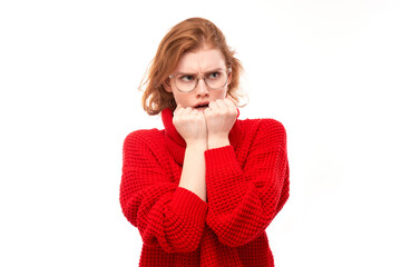 Portrait of scared young woman nervously biting nails isolated on white background. Stress,...