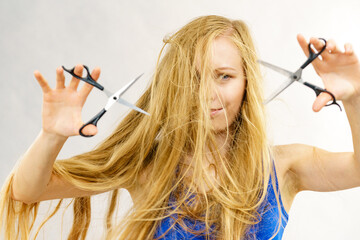 Girl with scissors for haircutting