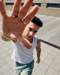 portrait of a person wearing vest and baggy jeans