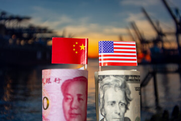 A roll of USD with the American flag and a bundle of Chinese Yuan and the Chinese national flag...