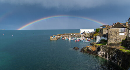 Fototapeta na wymiar Coverack harbour landscape with rainbow and stormy skies