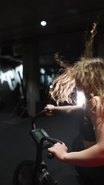 female running on elliptical orbitrek machine in fitness gym. Slow motion