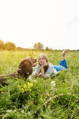 Close view of a woman petting spaniel with brown fur and opened mouth.