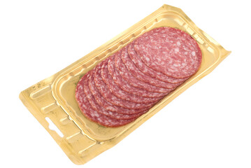 Sliced delicious sausage servelat on a plastic package isolated on a white background.