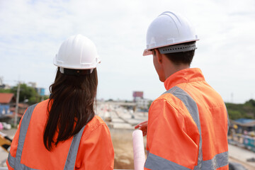 Surveyor site engineer with total positioning station on the construction site of the new road construction.