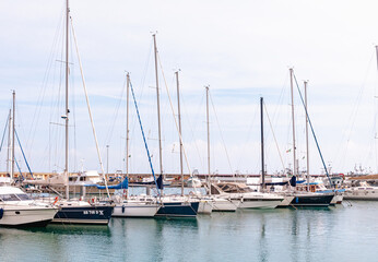 Front view, far distance of, a  row of, tall, sailing ships, moored, at an Italian harbor, on Adriatic coastline