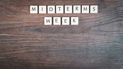 Back to school concept. Finals week word on wooden desk.