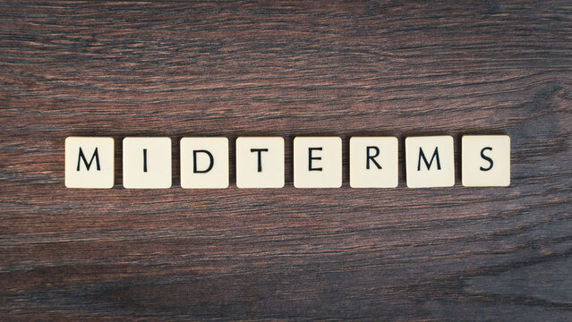 Back to school concept. Finals week word on wooden desk.