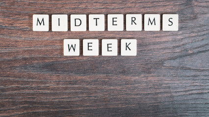 Back to school concept. Finals week word on wooden desk.