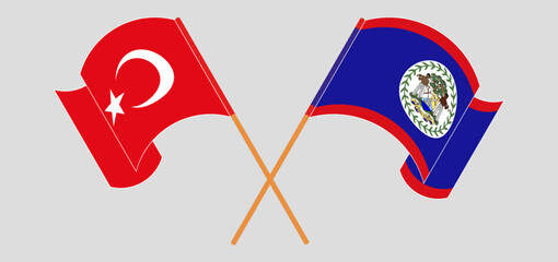 Crossed and waving flags of Turkiye and Belize