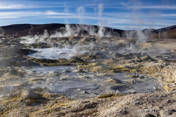 Stunning geothermic field of Sol de Mañana with its steaming geysers and hot pools with bubbling mud - just one sight on the lagoon route in Bolivia, South America