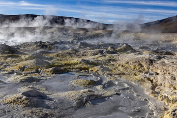 Stunning geothermic field of Sol de Mañana with its steaming geysers and hot pools with bubbling mud - just one sight on the lagoon route in Bolivia, South America