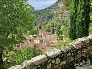Fototapeta na wymiar View of historic Moustiers-Sainte Marie, village in Provence near Gorge du Verdon with steps up to church on hilltop
